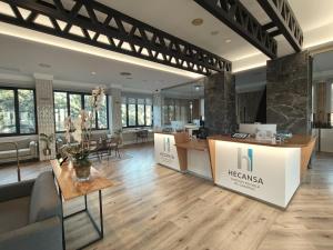 a large lobby with a reception desk and tables at Hotel Escuela Santa Brígida in Santa Brígida