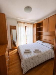 a bedroom with a bed with two towels on it at Villa Nona with swimming pool in Dornberk