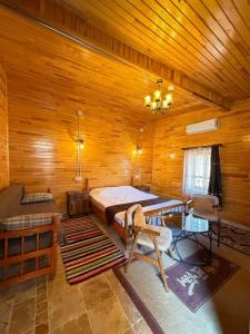 a bedroom with a bed in a wooden room at Ela Sultan Han Otel in Gaziantep