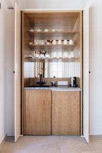 a kitchen with wooden cabinets and a counter top at Galetso Studios by Still Collection in Nikiti