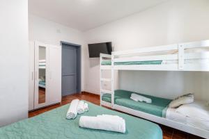 a bedroom with two bunk beds and a mirror at Blue Terrace Guest House in Alghero