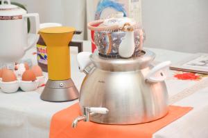 a tea kettle sitting on top of a table at Lian Room B&B in Caserta