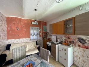 a living room with a couch and a kitchen at Rifugio Nel Cuore Dell'Abruzzo in Carpineto Sinello