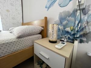 a bedroom with a bed and a table with a telephone at Rifugio Nel Cuore Dell'Abruzzo in Carpineto Sinello