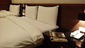 Postel nebo postele na pokoji v ubytování Sun Sweet Hotel