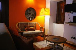 a living room with a chair and a table at Casa da Comareira in Góis