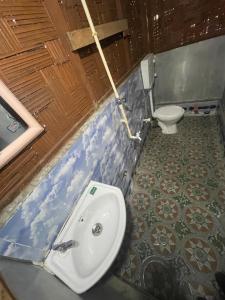 a bathroom with a sink and a toilet at Jungle Beach Resort in Neil Island