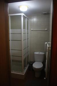 a bathroom with a toilet and a glass shower at Casa da Comareira in Góis +54 photos