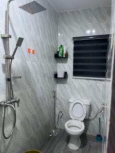 a bathroom with a shower and a toilet in it at RYN Apartment Ayobo-Ishefun, Lagos Flat1 in Itele