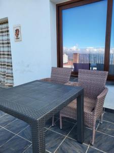 a table and chairs in a room with a view at Suite Émber-Fuego in Soportújar +4 photos