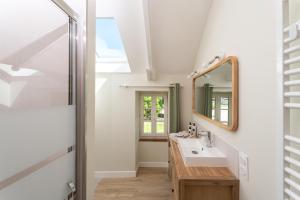 a bathroom with a sink and a mirror at B&B Clerval - Maison d'hôtes et Gîtes in Dragey