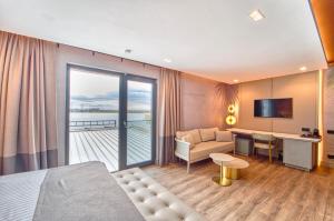 a hotel room with a bed and a couch and a desk at Duman Boutique Hotel in Mamaia