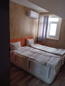 a bedroom with a large bed with a window at Hostel Center Plovdiv in Plovdiv