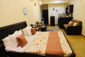 a bedroom with a bed and a living room at The Moksh in Haridwār