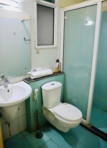 a bathroom with a toilet and a sink and a mirror at The Moksh in Haridwār