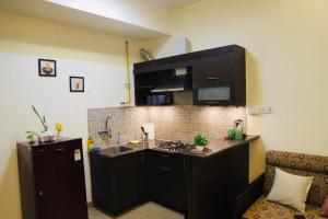 a kitchen with a sink and a counter top at The Moksh in Haridwār