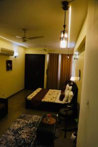 a hotel room with a bed and a chair at The Moksh in Haridwār