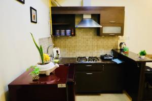 a kitchen with a stove and a counter top at The Moksh in Haridwār +7 photos