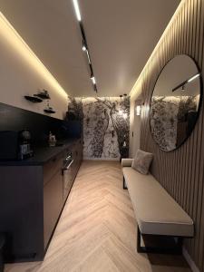 a living room with a mirror and a couch at Maison Nina, Suite d’exception in LʼÎle-Saint-Denis
