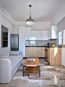 a living room with a couch and a table at Mouragio Stay - Aliki , Paros in Aliki +100 photos