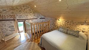 a bedroom in a log cabin with a bed at Le clédier de cherveix in Solignac