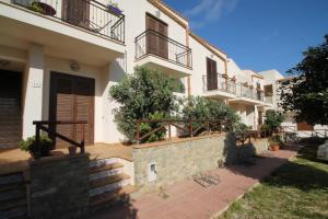 a house with balconies and stairs in front of it at 9 Nereide in San Vito lo Capo
