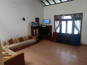 a living room with two couches and a television at LP Residence in Pannipitiya