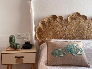 a bed with a large headboard and a pillow on it at B&B SEnDA de alegria in Cómpeta