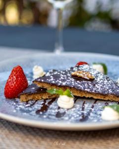 a plate of chocolate dessert with strawberries on a table at Logis Hôtel Auberge de Cartassac in Sarrazac