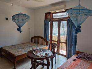 a dining room with a table and a window at LP Residence in Pannipitiya