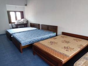two beds sitting in a room with at LP Residence in Pannipitiya