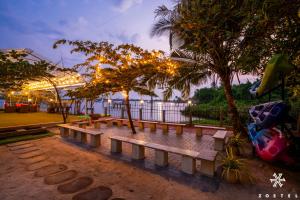 a row of benches in a park at night at Zostel Kochi, Kumbalangi in Cochin