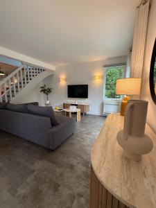 a living room with a couch and a table at Casa Limon, Charm & Serenity in Cesson-Sévigné