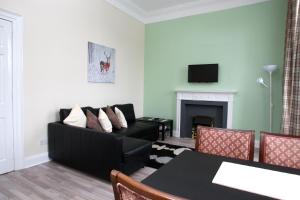 a living room with a couch and a table at 52 Charlotte Street , Glasgow green ,City Center in Glasgow