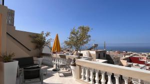 a balcony of a building with a view of the ocean at Villa Michel in Tamraght Ouzdar