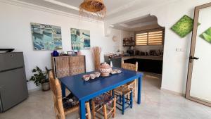 a blue table with chairs in a kitchen at Villa Michel in Tamraght Ouzdar