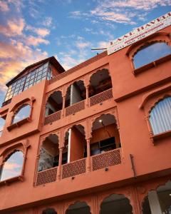 a red building with windows on the side of it at Laal Haveli Kukas in Jaipur