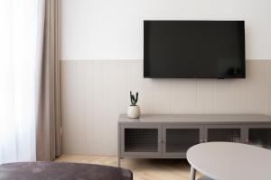 a living room with a flat screen tv on a wall at Calma Apartament Moderato in Starogard Gdański