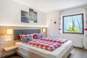 a bedroom with a large bed and a window at Altvogtshof in Furtwangen