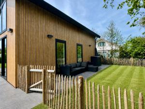 a wooden fence in front of a house at LouLou Beachhouse in Julianadorp