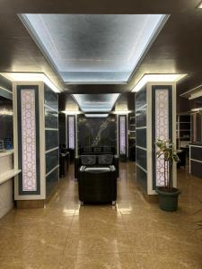 a room with a salon with a chair and a table at Gold Hotel in Istanbul