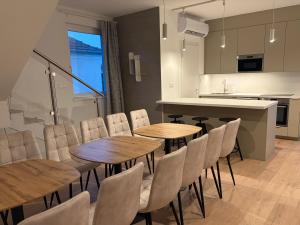 a kitchen and dining room with wooden tables and chairs at Ady80 in Balatonmáriafürdő
