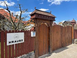 a wooden fence with a gate with a sign on it at Krausz Chocolate Guesthouse in Sîntimbru +2 photos