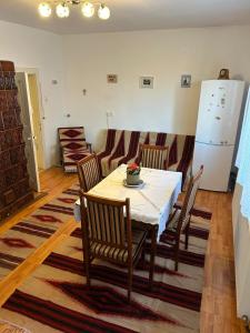 a kitchen with a table and chairs and a refrigerator at Krausz Chocolate Guesthouse in Sîntimbru