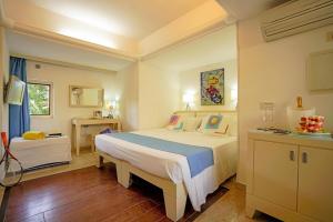 a bedroom with a large bed in a room at Hotiday Torre Santo Stefano Resort in Otranto