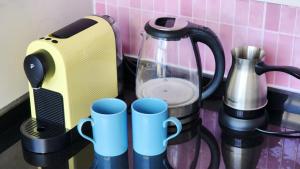 a kitchen counter with a blender and cups on it at Blue Marine in Kalogrea