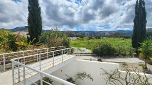 a white staircase with trees and a field in the background at Blue Marine in Kalogrea +3 photos