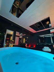 a large tub in a room with a living room at Ama Collection Esclusive Spa in Bologna