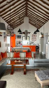 a living room with a couch and a table at Casa Baleia Laranja Ocean-Front in Madalena