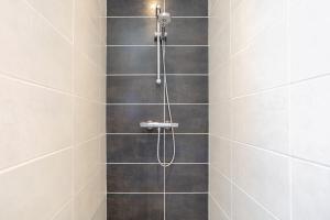 a shower with a shower head in a bathroom at La maison du verger in Loctudy +28 photos